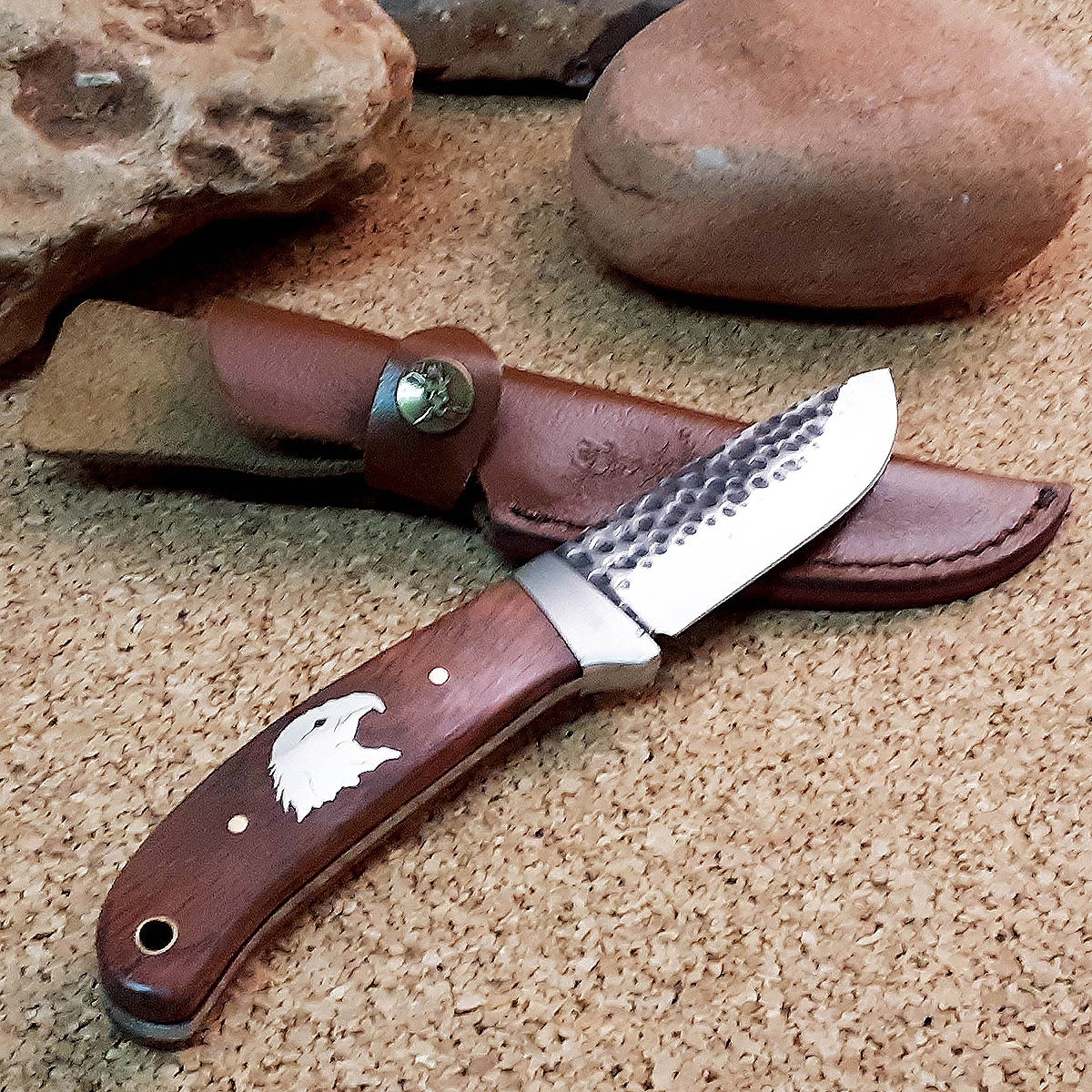 https://www.joewilcoxsedona.com/wp-content/uploads/2021/06/Eagle-Head-Hammered-Steel-Fixed-Blade-3.jpg