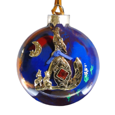 Blue and gold Southwest glass Christmas ornament featuring a coyote, crescent moon, stars and desert cactus accents