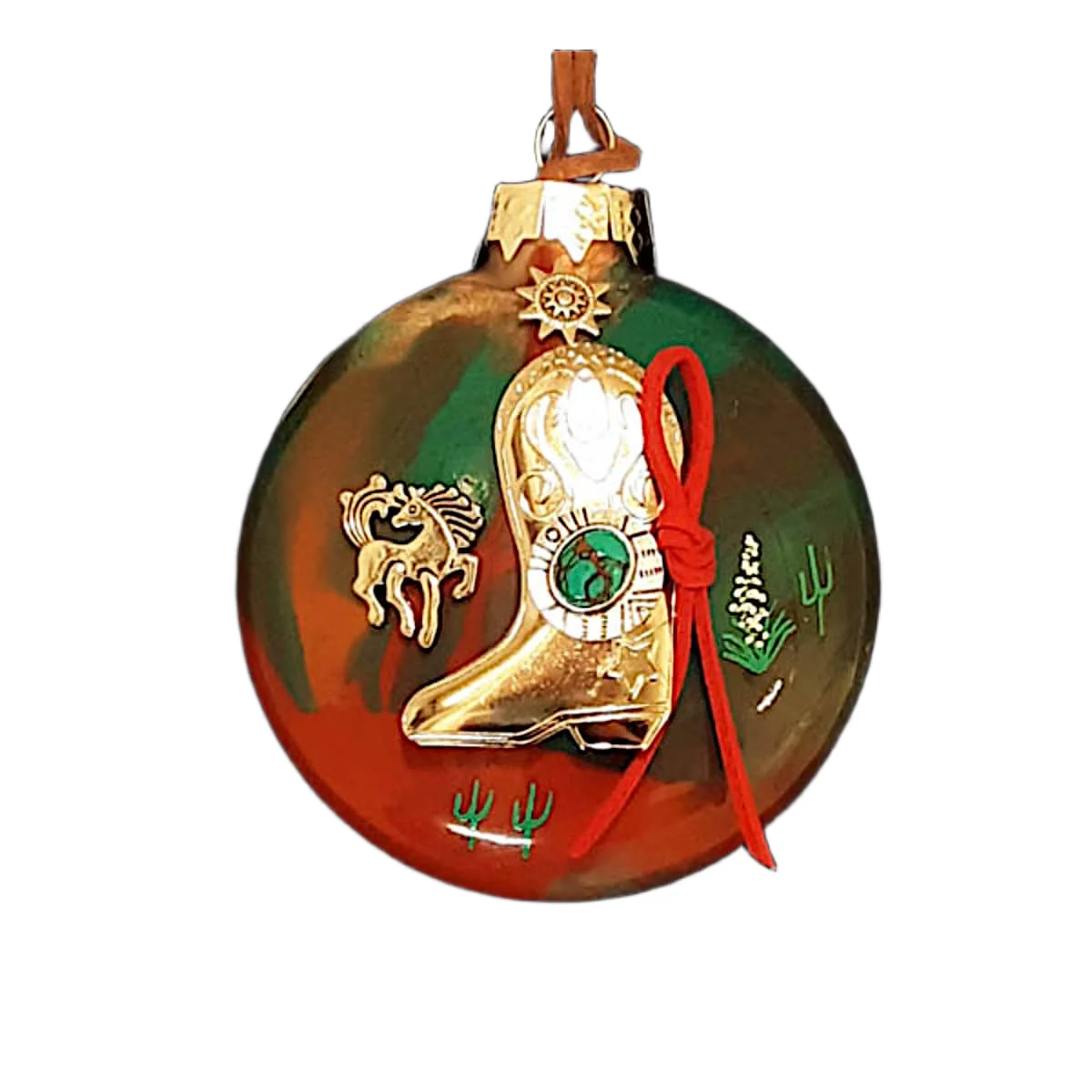 Green and terracotta glass Southwest ornament featuring a gold cowboy boot charm with green turquoise emblem, red suede tie, gold horse motif, and sun emblem.
