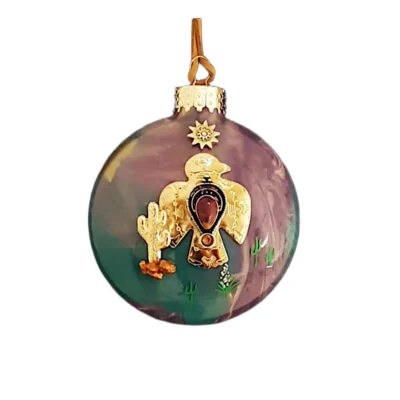 Muted purple and green glass Southwest ornament featuring a gold Thunderbird charm with teardrop stone cabochon, gold cactus, and sun emblem.