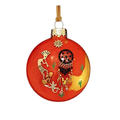 Orange and yellow glass Southwest ornament featuring a gold Kokopelli charm, black dreamcatcher with beaded fringe, lizard charm, and sun emblem.
