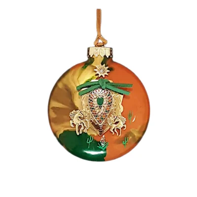 Orange, gold, and green glass Southwest ornament featuring a teardrop rosette shield charm, green suede tie, wild horses, and sun emblem.