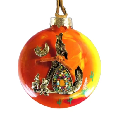 Orange and yellow sunset glass Southwest ornament featuring a silver howling coyote charm with colorful inlaid teardrop rosette, small howling wolves, and crescent moon motif.