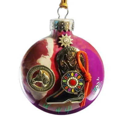 Purple glass Western ornament featuring a metallic cowboy boot with colorful rosette emblem, horse head medallion, and sun charm.