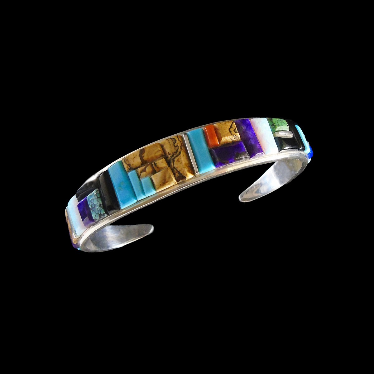 Handmade Navajo sterling silver cuff with cobblestone inlay featuring lapis, onyx, jasper, turquoise, opal, and spiny oyster. Authentic Southwest jewelry.