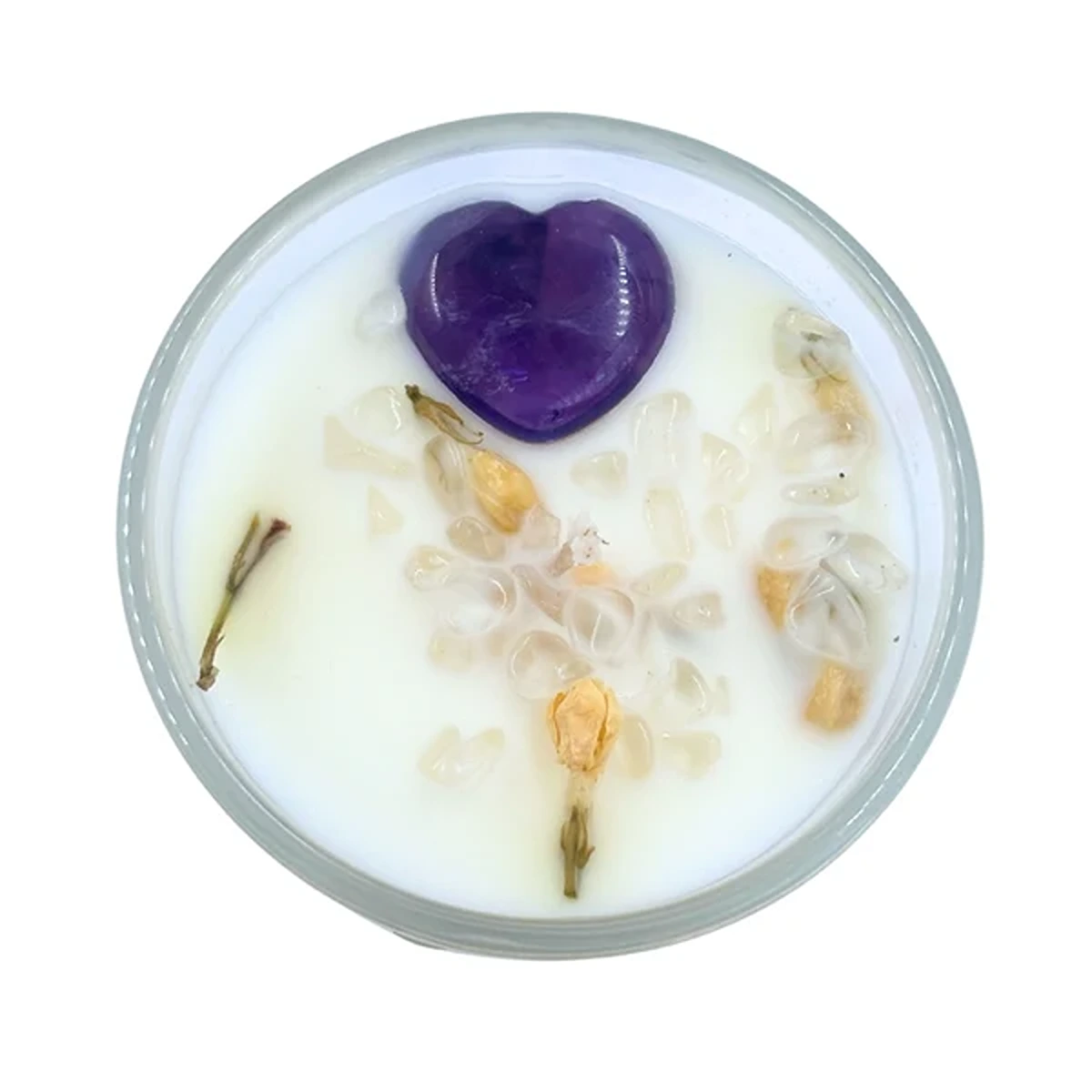 Top-down view of a round dish with milky liquid, a purple heart-shaped object, and scattered translucent crystals or petals on top.